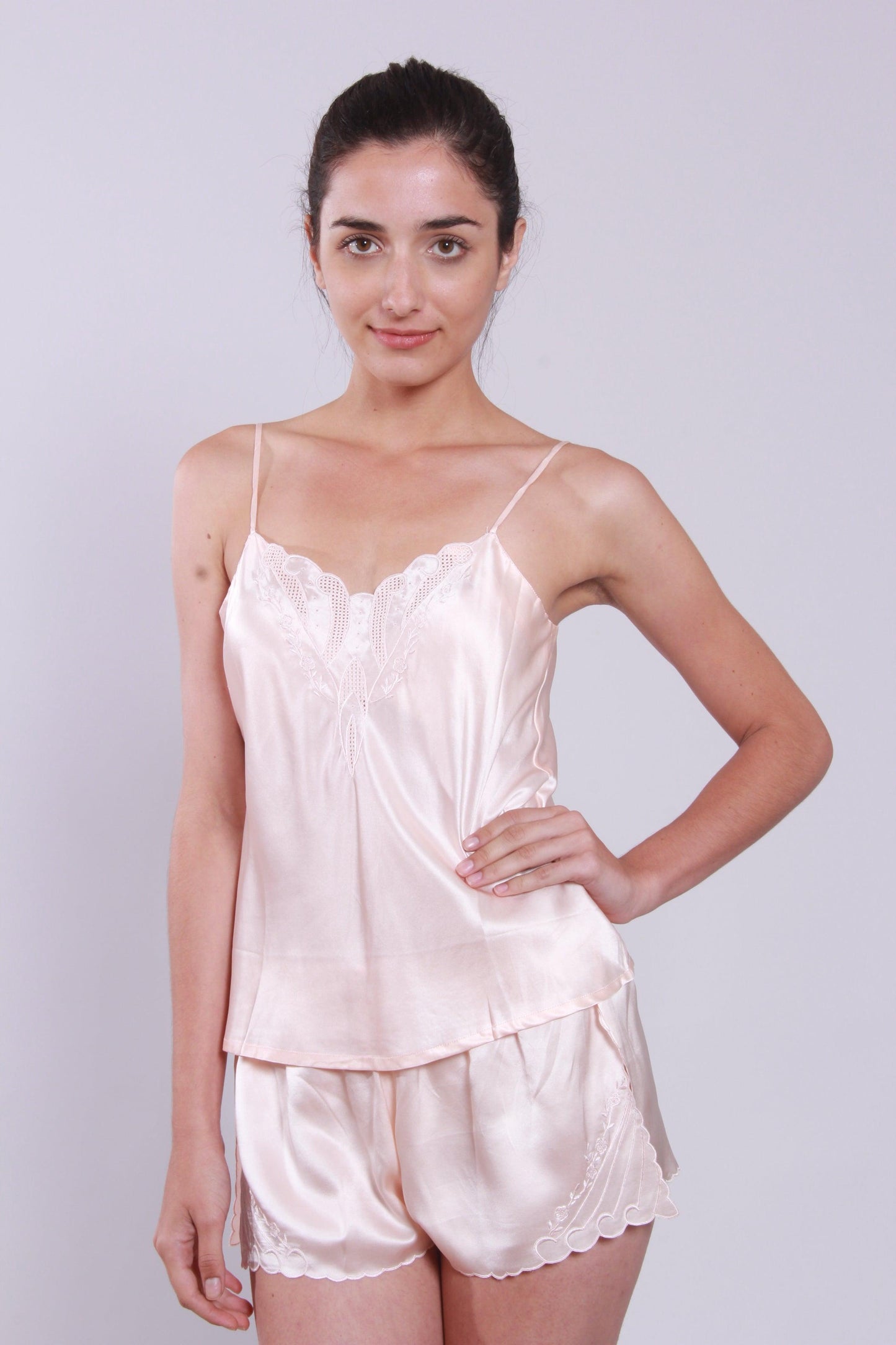 Including a camisole and a matching Frenchmen, this sweet two-piece silk lingerie set features pure high-quality satin silk, delicate handmade embroidery along neckline and hemline of camisole, the front lower left corner of panty and fantastic comfy cool; side slits on the hem of panty make it sweet and flirty.